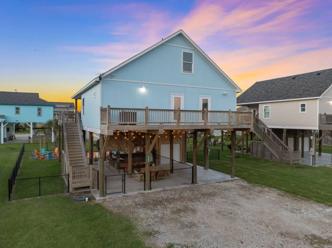 Rear exterior view with covered patio, deck, and fenced yard.