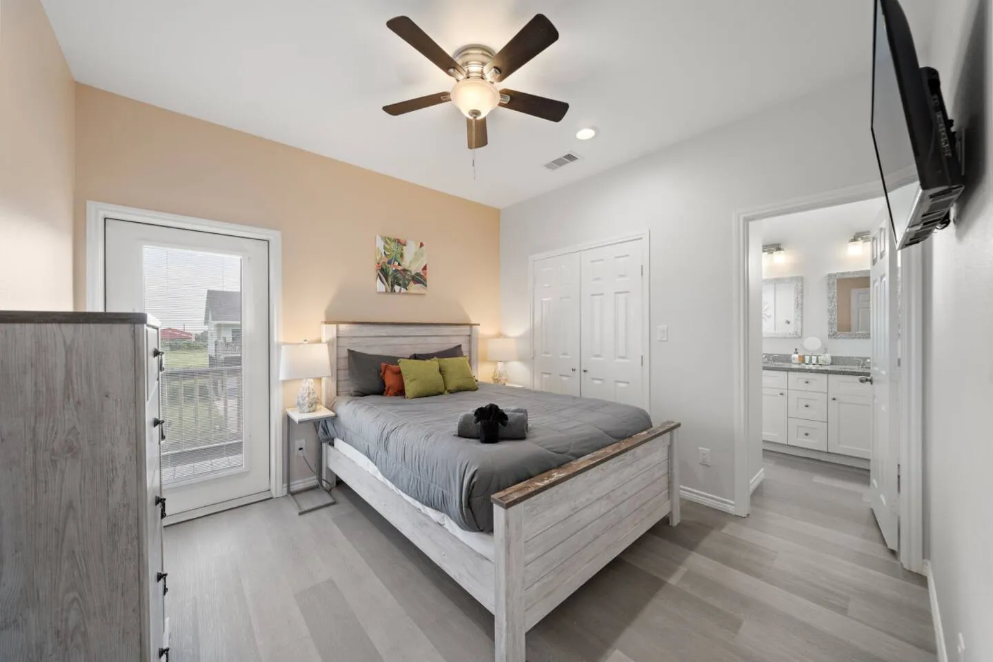 Queen bedroom with bright coastal style and space to unpack.