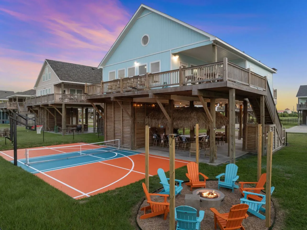 Backyard view with private court, firepit seating, and covered deck.