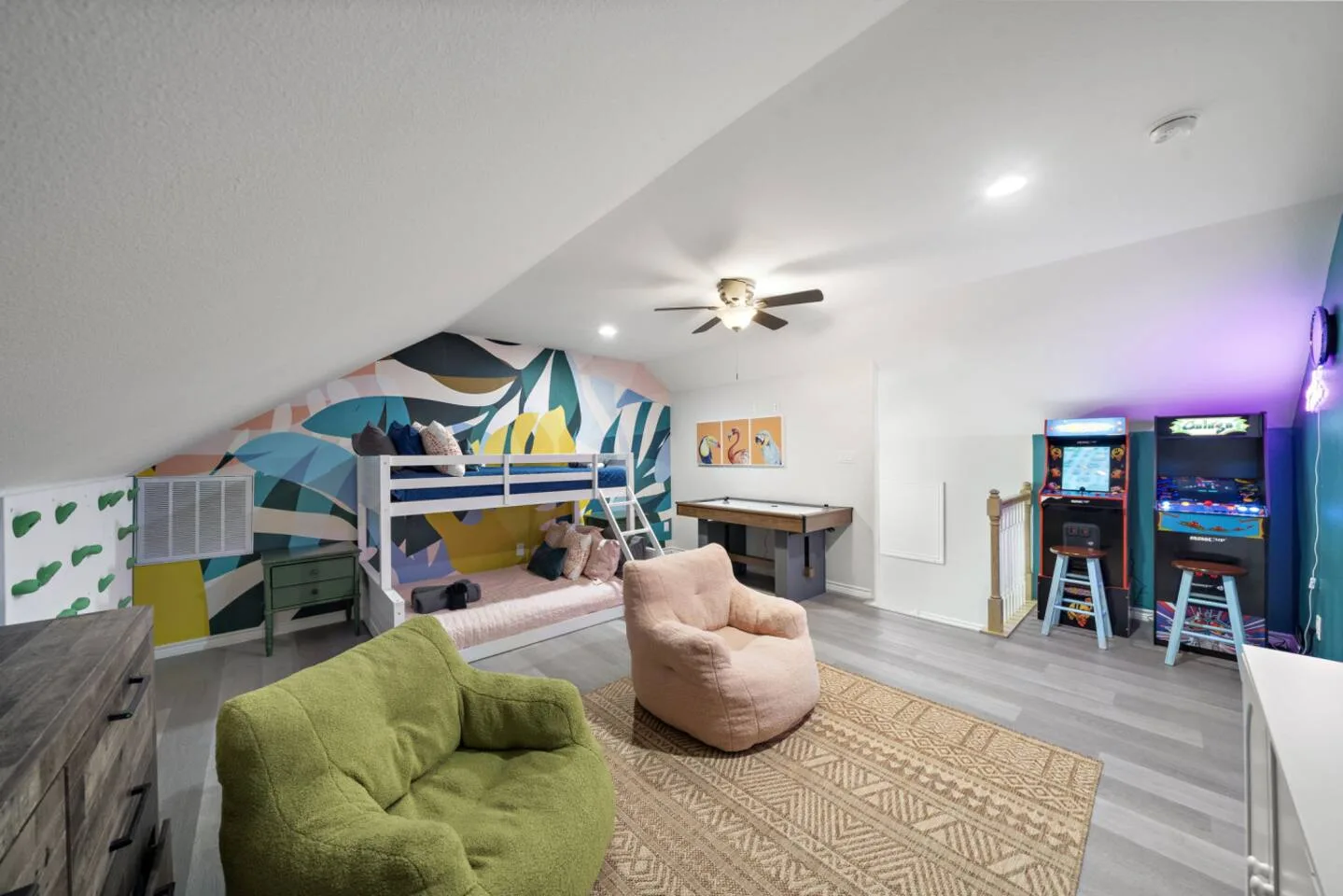 Game loft with arcade games, TV, and space for kids or adults to hang out.